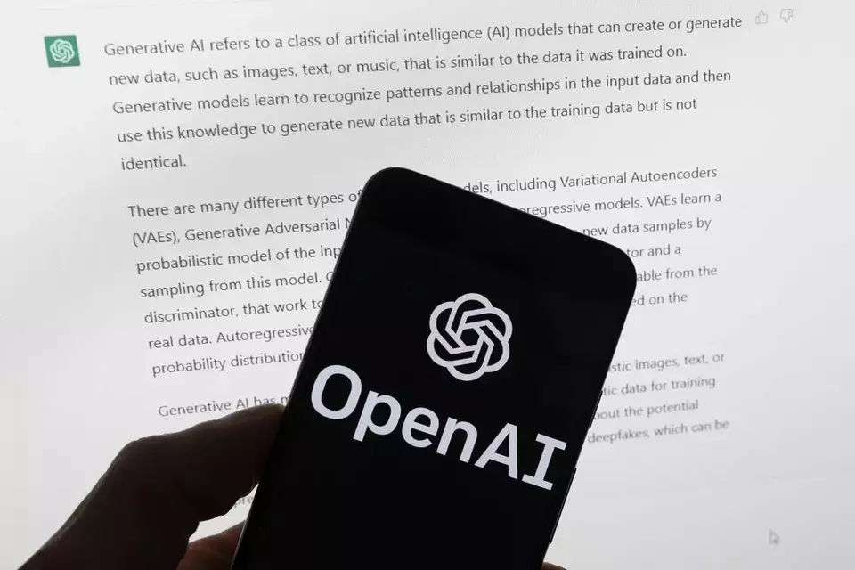 FILE - The OpenAI logo is seen on a mobile phone in front of a computer screen displaying output from ChatGPT, March 21, 2023, in Boston. (AP Photo/Michael Dwyer, File)