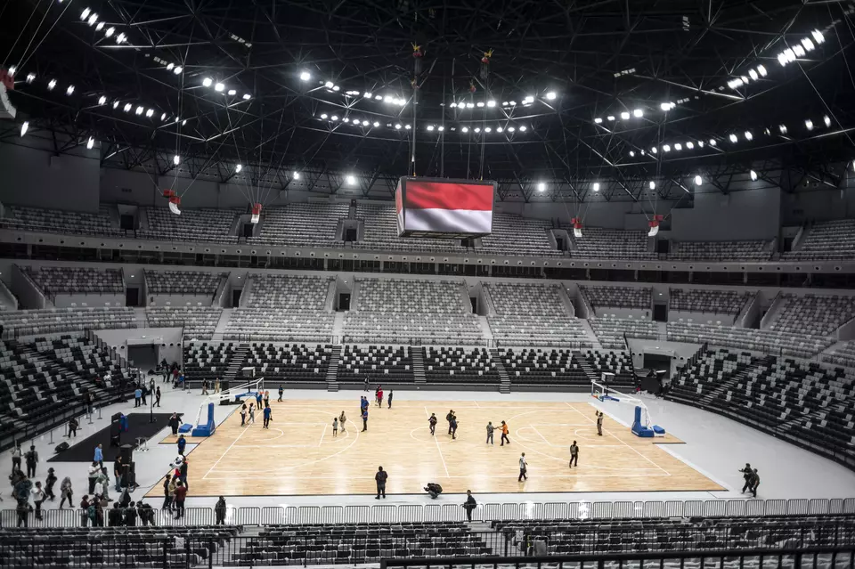 Workers resurface the floor of the newly-built Indonesia Arena indoor stadium in Jakarta on July 11, 2023, as preparation underway for FIBA World Cup marches. (Antara photo/Aprillio Akbar)