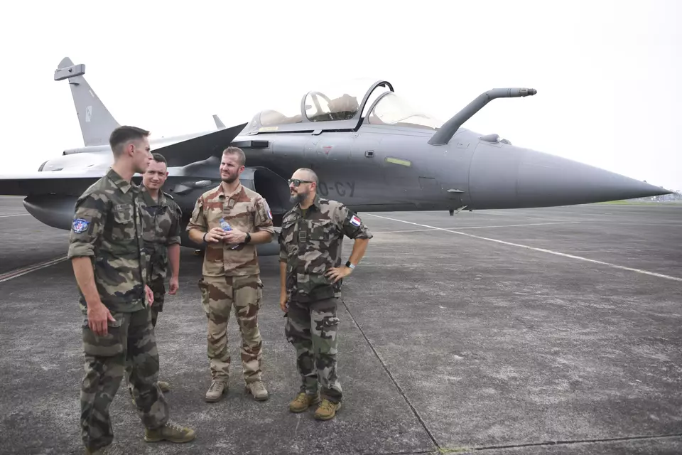 Four French Air Force officers stands near a Rafale fighter jet on the tarmac of Halim Perdanakusuma Air Force Base in East Jakarta, Wednesday, July 26, 2023. (Antara photo/M Risyal Hidayat)