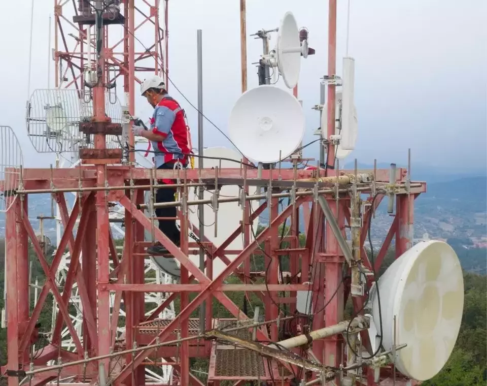 In this undated photo, a Mitratel worker inspects the telecommunication tower. (Handout)