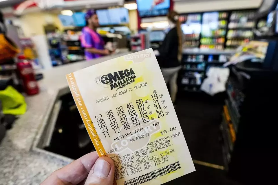 A Mega Millions ticket is seen as a person makes a purchase inside a convenience store, ahead Mega Millions drawing of $1.55 billion, Monday, Aug. 7, 2023, in Kennesaw, Ga. There now have been 31 straight drawings without a big jackpot winner. (AP Photo/Mike Stewart)