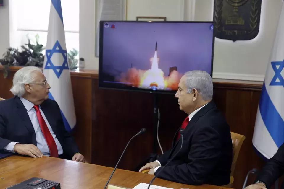 FILE - Israeli Prime Minister Benjamin Netanyahu, right, and US Ambassador to Israel David Friedman watch a video which shows the launch of the Arrow 3 hypersonic anti-ballistic missile during a cabinet meeting in Jerusalem on July 28, 2019. (Menahem Kahana/Pool via AP, File)