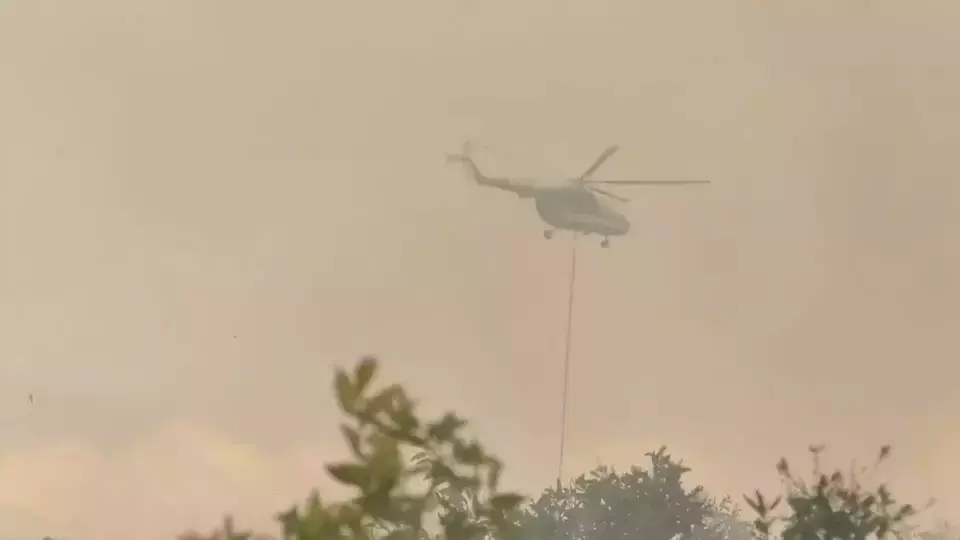 FILE - A helicopter belonging to the National Disaster Mitigation Agency (BNPB) conducts an aerial firefighting operation in the South Kalimantan town of Banjarbaru, Friday, Aug. 18, 2023. (B-Universe photo/Fuad Iqbal Abdullah)