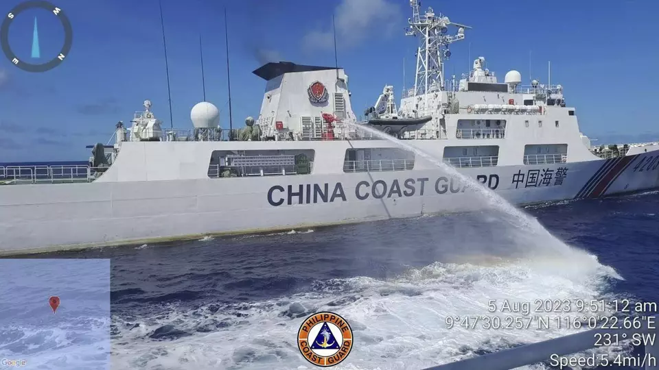 In this handout photo provided by the Philippine Coast Guard, a Chinese coast guard ship uses water canons on a Philippine Coast Guard ship near the Philippine-occupied Second Thomas Shoal, South China Sea as they blocked its path during a re-supply mission on Saturday, Aug. 5, 2023. (Philippine Coast Guard via AP)