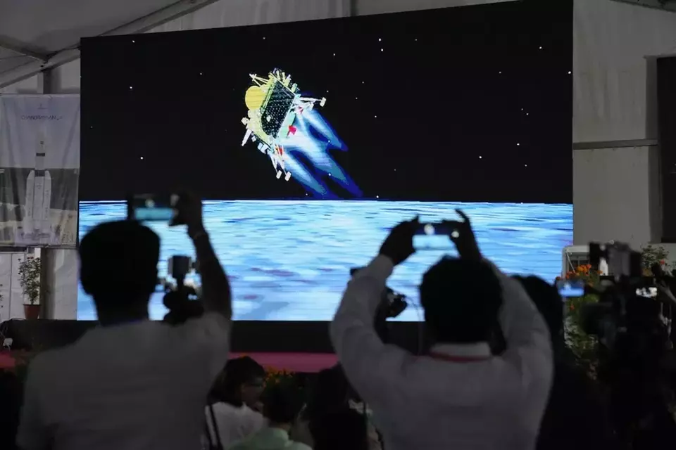 Journalists film the live telecast of spacecraft Chandrayaan-3 landing on the moon at ISRO