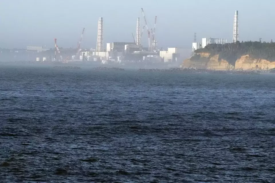 The Fukushima Daiichi nuclear power plant, damaged by a massive March 11, 2011, earthquake and tsunami, is seen from the nearby Ukedo fishing port in Namie town, northeastern Japan, Thursday, Aug. 24, 2023. The Fukushima Daiichi nuclear power plant will start releasing treated and diluted radioactive wastewater into the Pacific Ocean as early as Thursday. (AP Photo/Eugene Hoshiko)