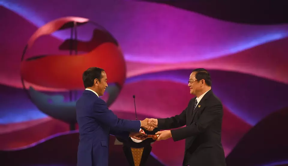 President Joko "Jokowi" Widodo gives a gavel to Laos
