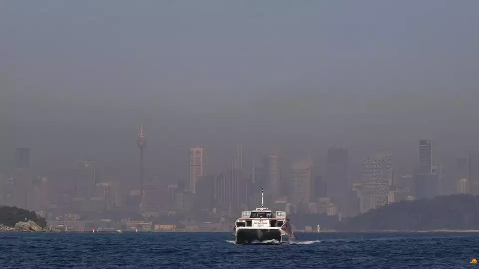 A passenger ferry arrives at a wharf in Watsons Bay as a thick blanket of smoke hangs over parts of Sydney following New South Wales Rural Fire Service (RFS) hazard reduction burns in the past week, Thursday, Sept. 14, 2023. (AP Photo/Mark Baker)