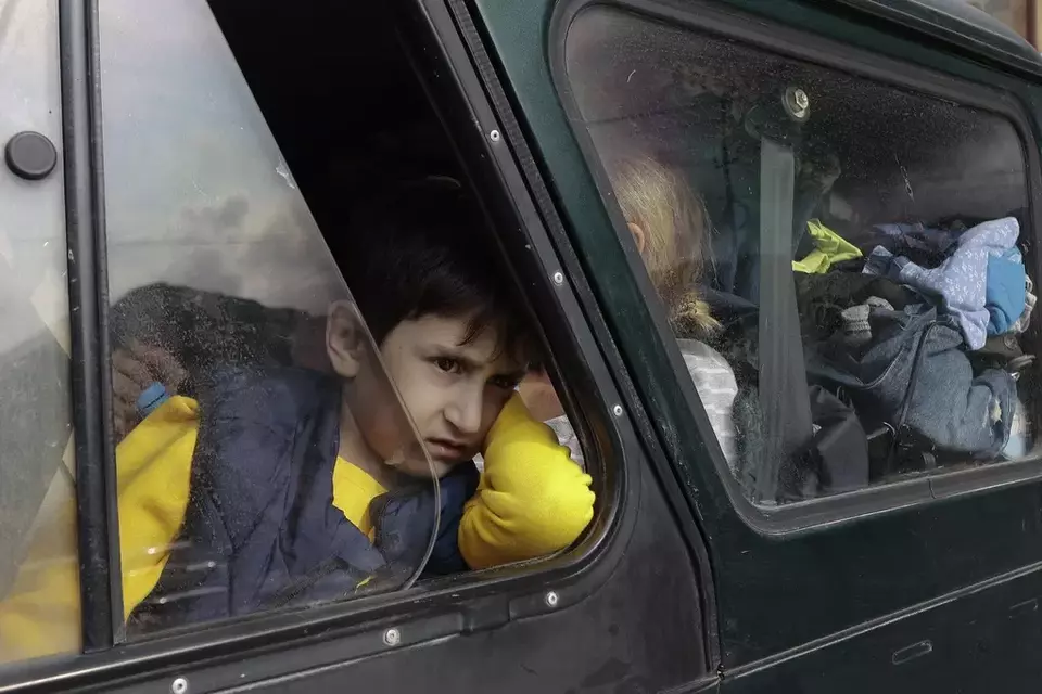An ethnic Armenian boy from Nagorno-Karabakh looks on from a car upon arrival in Armenia