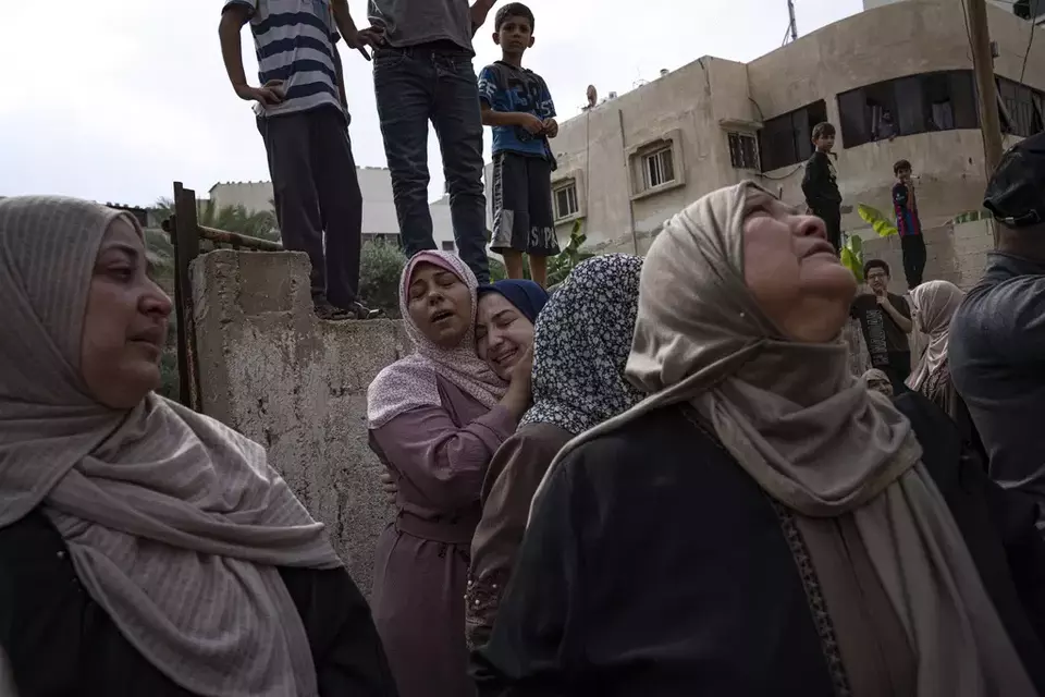 Relatives mourn people killed in an Israeli air strike in Gaza City on Monday, Oct. 9, 2023. (AP Photo/Fatima Shbair)