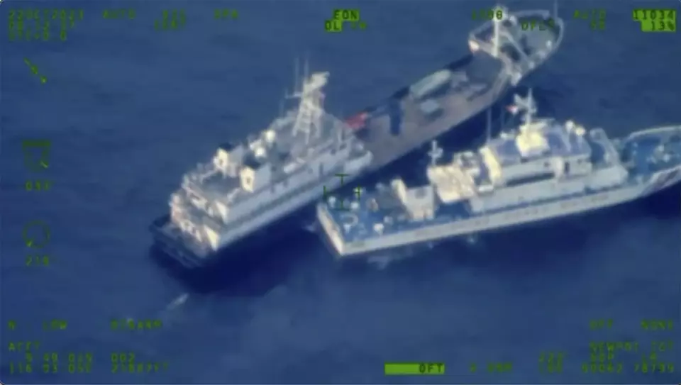 FILE - This image released by the Armed Forces of the Philippines, shows a Chinese militia vessel, top, and Philippine coast guard vessel BRP Cabra as they approach Second Thomas Shoal, locally called Ayungin Shoal, at the disputed South China Sea on Sunday, Oct. 22, 2023. (Armed Forces of the Philippines via AP)