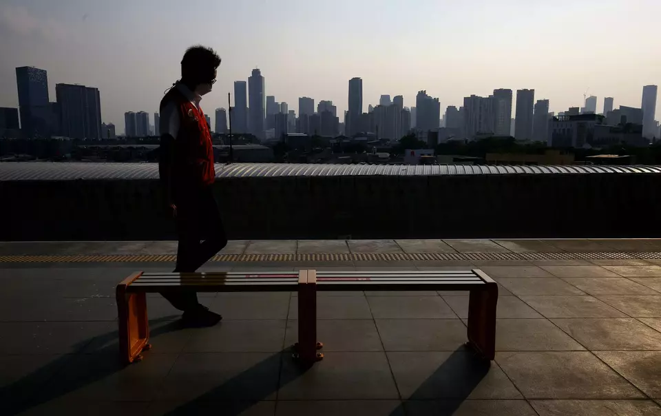 This 2021 file photo shows a commuterline passenger walking along the platform at Manggarai Station, with high-rise buildings in Jakarta forming the backdrop. (B1 Photo/Joanito De Saojoao)