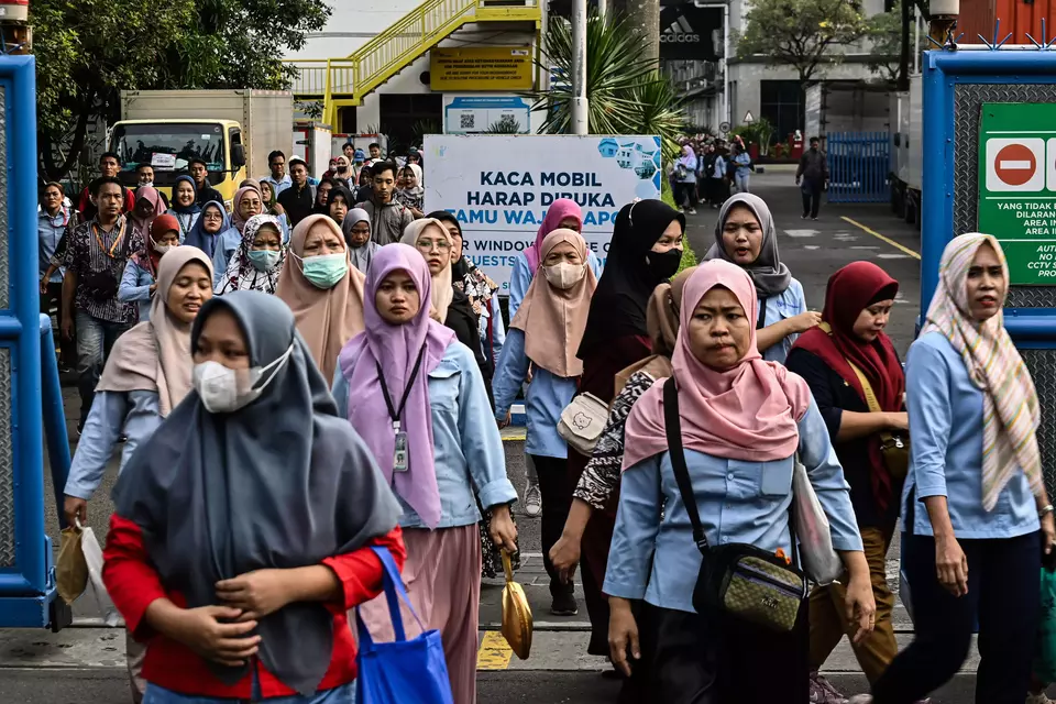 Female workers walk out of a factory in Tangerang, Banten province, after a work shift, Friday, Nov. 17, 2023. (Antara Photo/Sulthony Hasanuddin)