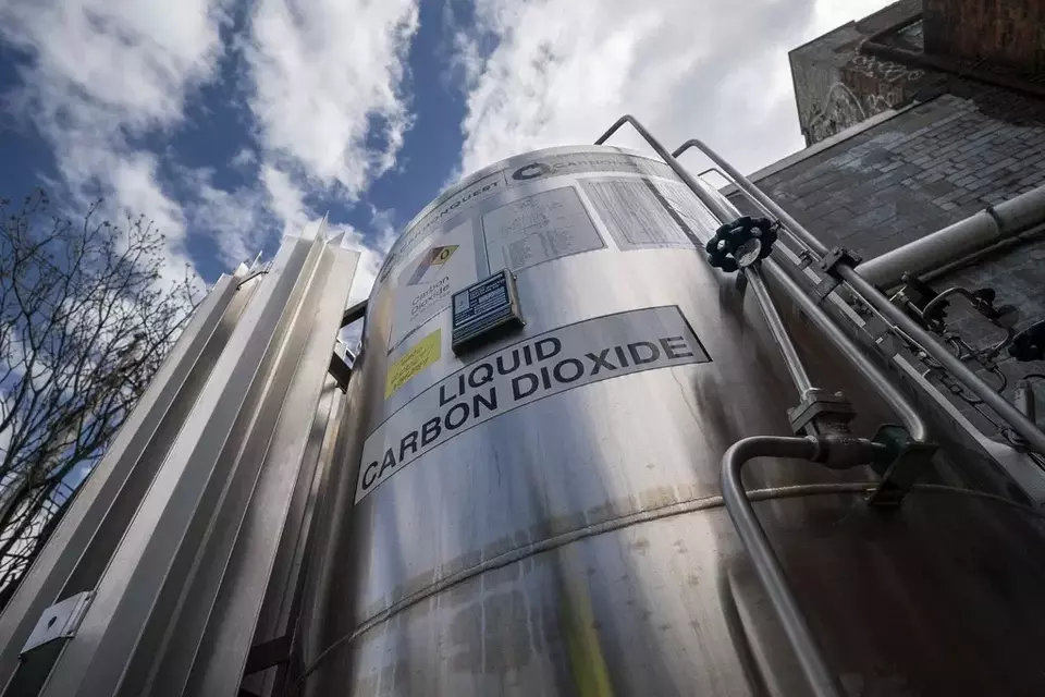 FILE - A liquid carbon dioxide containment unit stands outside the fabrication building of Glenwood Mason Supply Company, April 18, 2023, in the Brooklyn borough of New York. (AP Photo/John Minchillo, File)