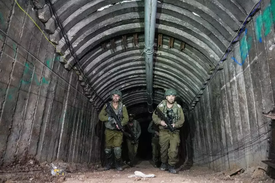 Israeli soldiers are seen in a tunnel that the military says Hamas militants used to attack the Erez crossing in the northern Gaza Strip, Friday, Dec. 15, 2023. (AP Photo/Ariel Schalit)