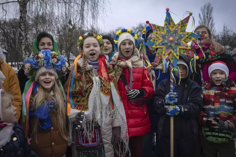 Children dressed in national suits sing carols as they celebrate Christmas in the village of Pirogovo outside the capital Kyiv, Ukraine, Monday, Dec. 25, 2023. (AP Photo/Efrem Lukatsky)