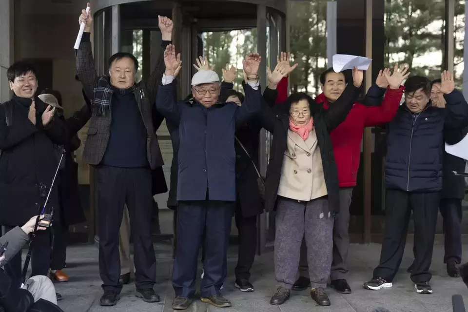 Family members of victims react outside the Supreme Court of Korea in Seoul, South Korea, Thursday, Dec. 28, 2023. South Korea