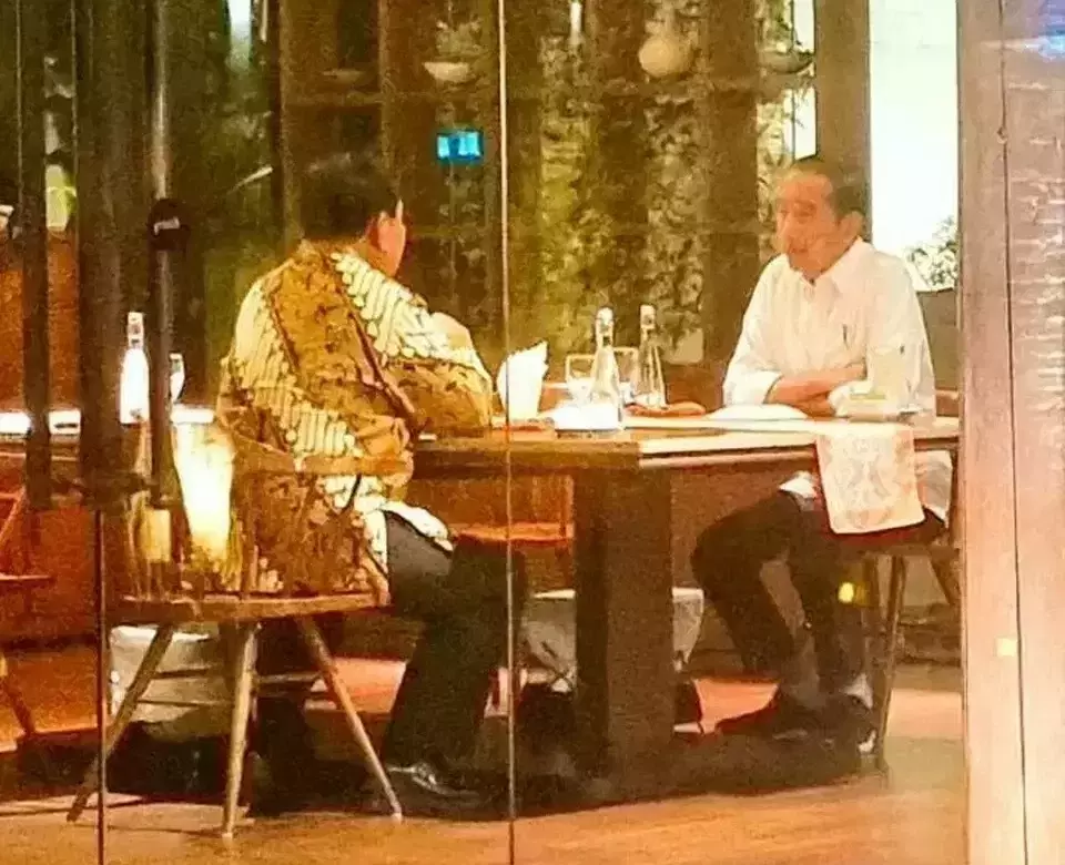 In this photo distributed to members of the media, President Joko Widodo, right, shares dinner with presidential candidate Prabowo Subianto at a Jakarta restaurant, Friday, Jan. 5, 2024.