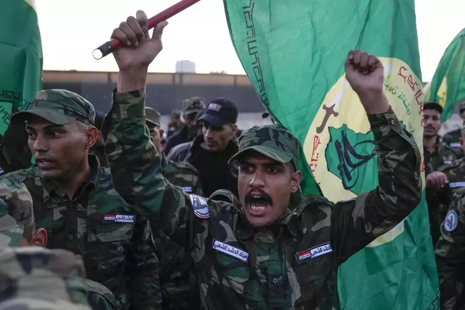 Members of an Iraqi Shiite militant group attend the funeral of Mushtaq Taleb al-Saidi or  Abu Taqwa who was killed in a US airstrike Province, in Baghdad, Iraq, Thursday, Jan. 4, 2024. (AP Photo/Hadi Mizban)