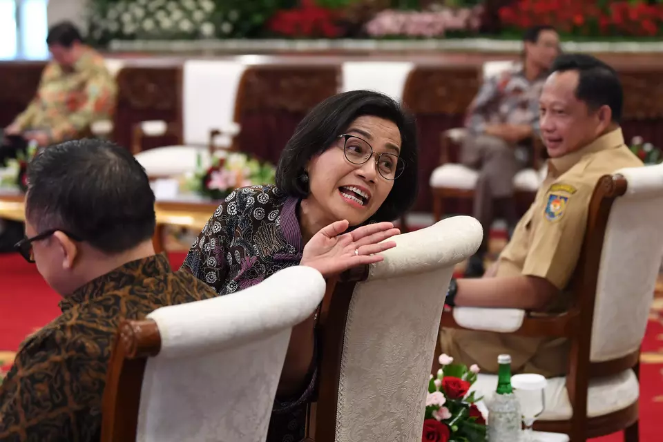 Finance Minister Sri Mulyani Indrawati, center, and Home Affairs Minister Tito Karnavian, right, attend a cabinet meeting at the State Palace in Jakarta, Tuesday, Jan. 9, 2024. (Antara Photo/Sigid Kurniawan)