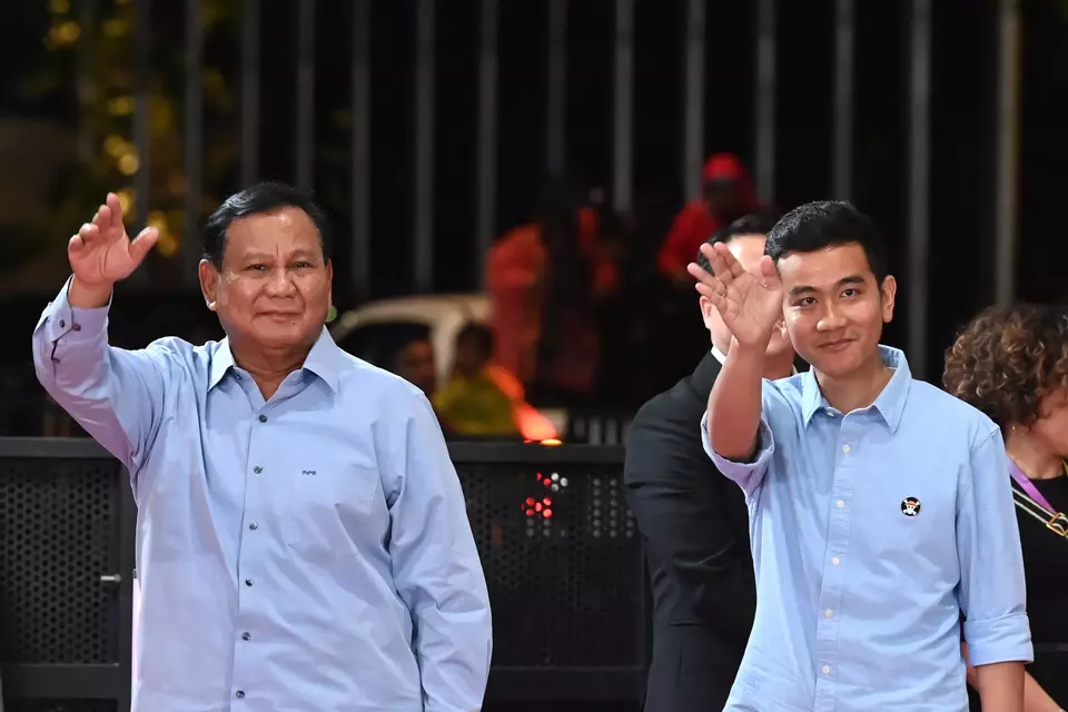 Presidential candidate Prabowo Subianto, left, and his running mate Gibran Rakabuming Raka greet supporters as they arrive at the Jakarta Convention Center (JCC) to attend a debate, Sunday, Jan. 21, 2024. Antara Photo/Indrianto Eko Suwarso)