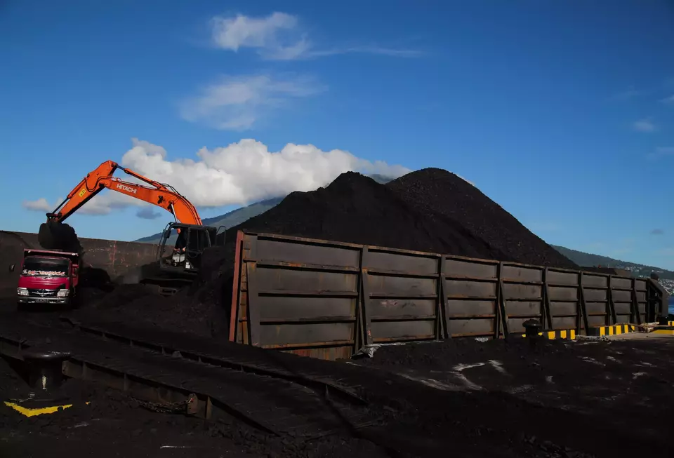 A backhoe unloads coal from a barge at Tidore Islands Port in North Maluku, Thursday, Jan. 4, 2024. (Antara Photo/Andri Saputra)