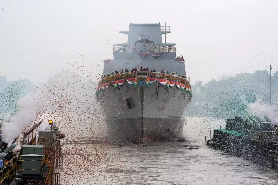 FILE- Confetti and smoke in the colors of the Indian national flag mark the entry of INS Vindhyagiri, a new warship for the Indian navy, into the Hooghly River in Kolkata, India, Aug. 17, 2023. (AP Photo/Bikas Das, file)