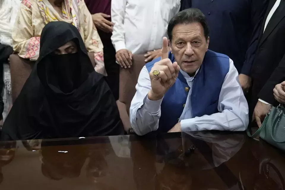 FILE - Pakistan s former Prime Minister Imran Khan, right, and Bushra Bibi, his wife, speak to the media before signing documents to submit surety bond over his bail in different cases, at an office of Lahore High Court in Lahore, Pakistan, on July 17, 2023. (AP Photo/K.M. Chaudary, File))