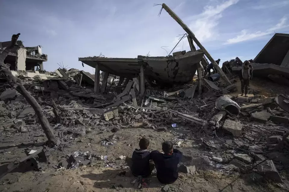 Palestinians inspect the damage to residential buildings where two Israeli hostages were reportedly held before being rescued during an operation by Israeli security forces in Rafah, southern Gaza Strip, Monday, Feb. 12, 2024.(AP Photo/Fatima Shbair)