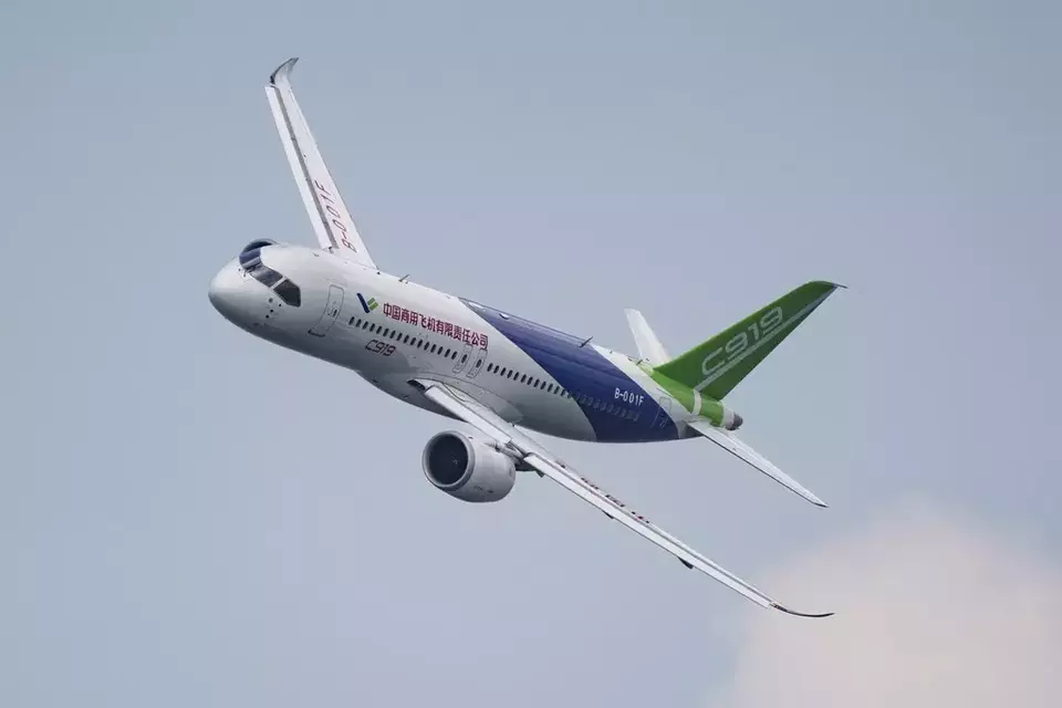 A China-made COMAC C919 aircraft flies during the first day of the Singapore Airshow in Singapore, Tuesday, Feb. 20, 2024. (AP Photo/Vincent Thian)