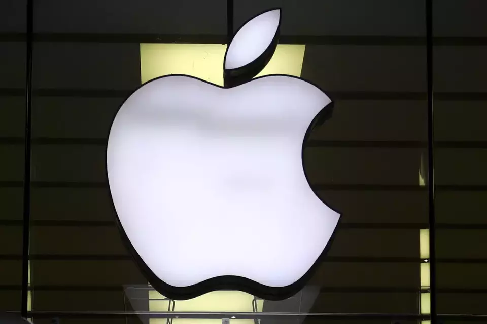 FILE - The Apple logo is illuminated at a store in the city center of Munich, Germany, Dec. 16, 2020. (AP Photo/Matthias Schrader, File)
