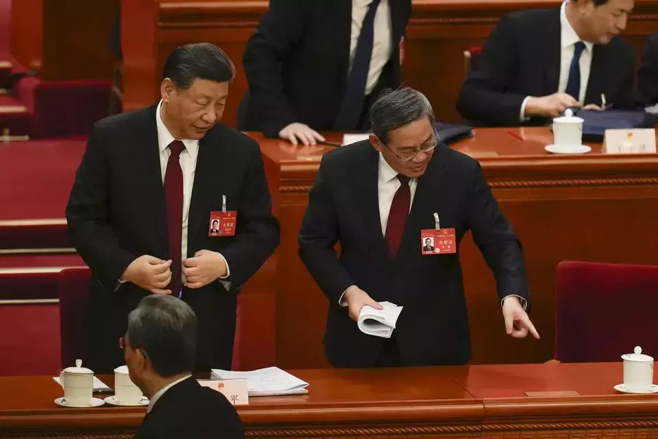 Chinese President Xi Jinping, left, listens to Chinese Premier Li Qiang after the opening session of the National People s Congress (NPC) at the Great Hall of the People in Beijing, China, Tuesday, March 5, 2024. (AP Photo/Ng Han Guan)