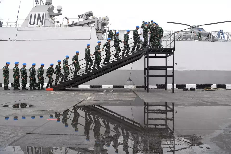 Members of the Garuda Peacekeeping Force ascend to the Frans Kaisiepo-368 Navy Ship for a ceremony at Tanjung Priok Port in North Jakarta, Tuesday, Feb. 6, 2024, after completing a mission with the United Nations for a year. (Antara Photo/Risyal Hidayat)