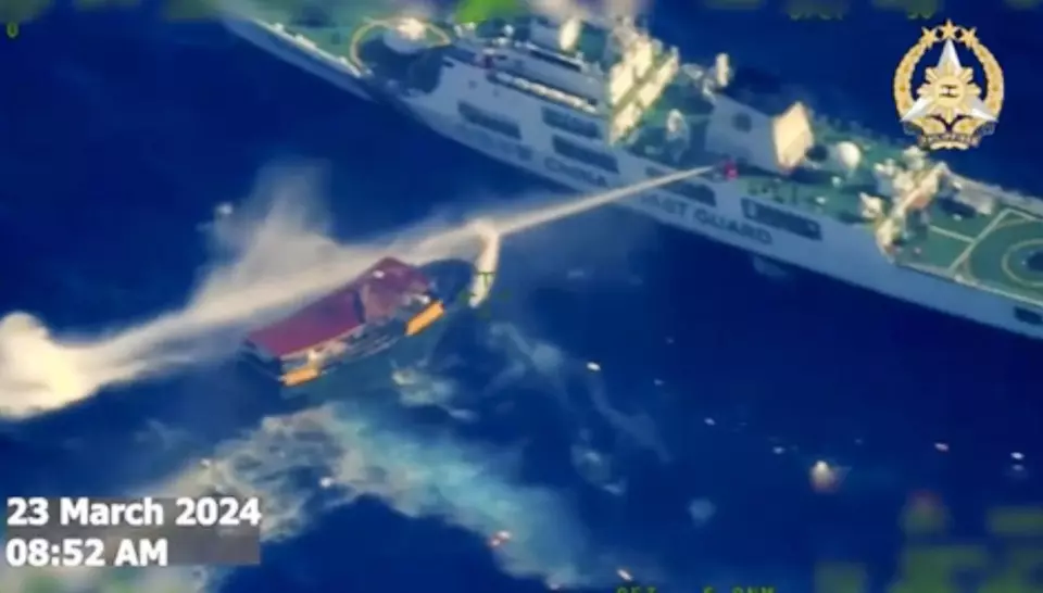 In this screen grab from a video provided by the Armed Forces of the Philippines, a Chinese coast guard ship uses water cannons on a Philippine resupply vessel Unaizah May 4 as it approaches Second Thomas Shoal, locally called Ayungin shoal, at the disputed South China Sea on Saturday, March 23, 2024. (Armed Forces of the Philippines via AP)