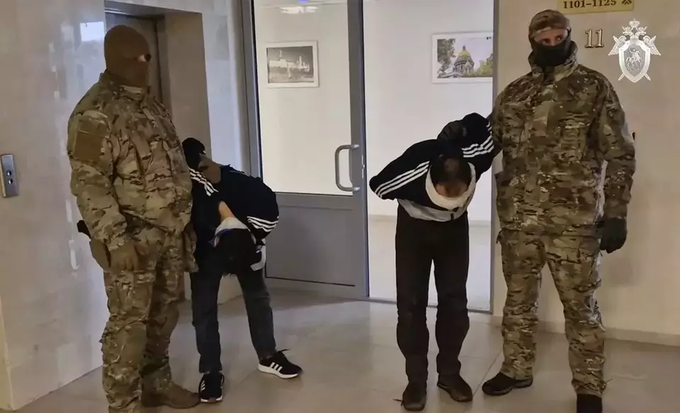 In this photo taken from a video released by the Investigative Committee of Russia on Sunday, March 24, 2024, suspects in the Crocus City Hall shooting two days earlier are escorted inside the Russian Investigative Committee headquarters in Moscow, Russia. (Investigative Committee of Russia via AP)
