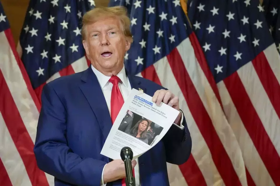FILE - Former President Donald Trump holds up a copy of a story featuring New York Attorney General Letitia James while speaking during a news conference, Jan. 11, 2024, in New York. (AP Photo/Mary Altaffer, File)