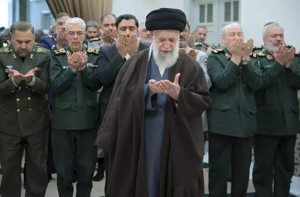 In this photo released by the official website of the office of the Iranian supreme leader, Supreme Leader Ayatollah Ali Khamenei, center, leads a prayer during his meeting with a group of senior military leaders, in Tehran, Iran, Sunday, April 21, 2024. (Office of the Iranian Supreme Leader via AP)