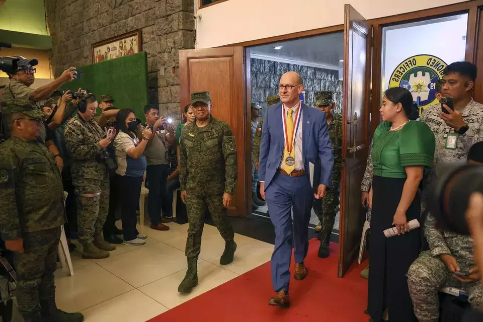 Philippine military Chief Gen. Romeo Brawner Jr., center left, and US Embassy Charge d Affaires, Robert Ewing, center right, arrive during the opening ceremonies of the "Balikatan" or Shoulder-to-Shoulder at Camp Aguinaldo military headquarters in Quezon City, Philippines on Monday April 22, 2024. (AP Photo/Basilio Sepe)