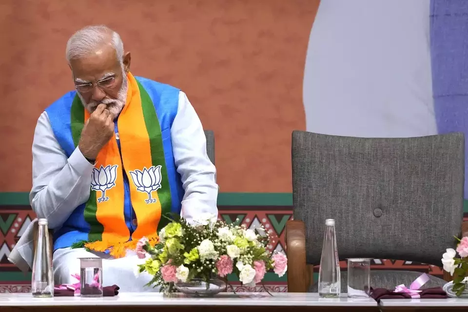 FILE- Indian Prime Minister Narendra Modi listens to Bharatiya Janata Party (BJP) President JP Nadda during an event organized to release their party s manifesto for the upcoming national parliamentary elections in New Delhi, India, April 14, 2024. (AP Photo/Manish Swarup, File)