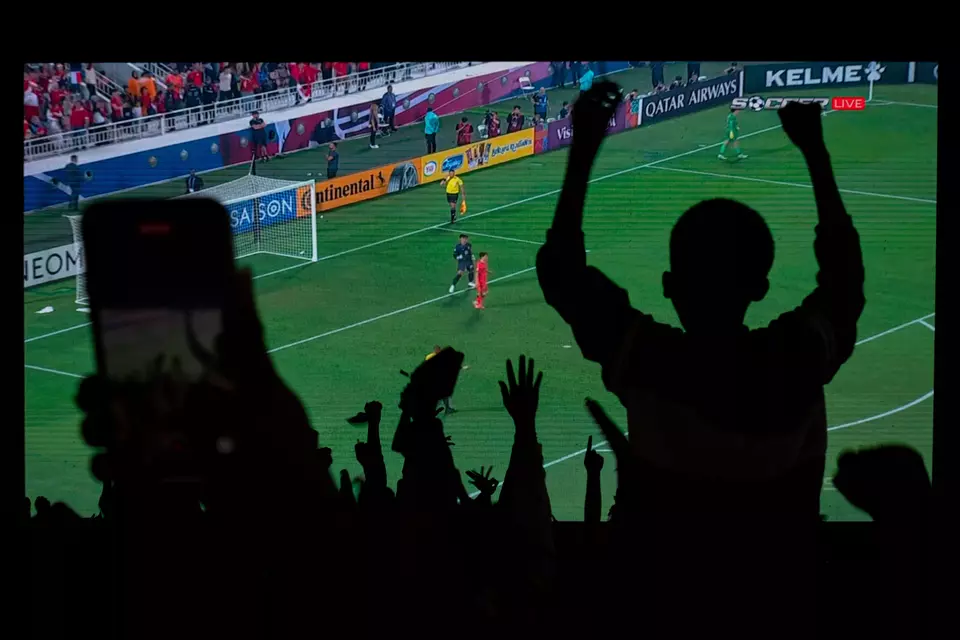 Semarang residents celebrate as Indonesian U-23 goalkeeper, Ernando Ari, saves a penalty kick from South Korean player Lee Kang Hee in the quarterfinals of the 2024 AFC U-23 Asian Cup. The match ended 2-2 after extra time, with Indonesia winning 11-10 in the penalty shootout, Friday, April 26, 2024. (PSSI)
