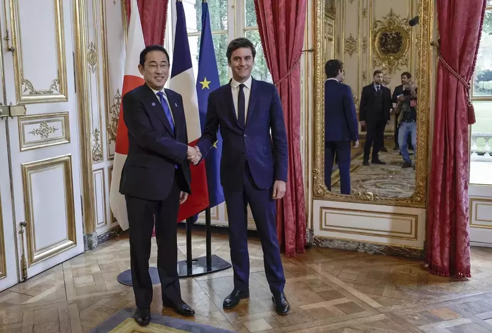 Japanese Prime Minister Fumio Kishida, left, is welcomed by French Prime Minister Gabriel Attal, right, at his office in Paris, Wednesday May 1, 2024. (Stephane de Sakutin, Pool via AP)