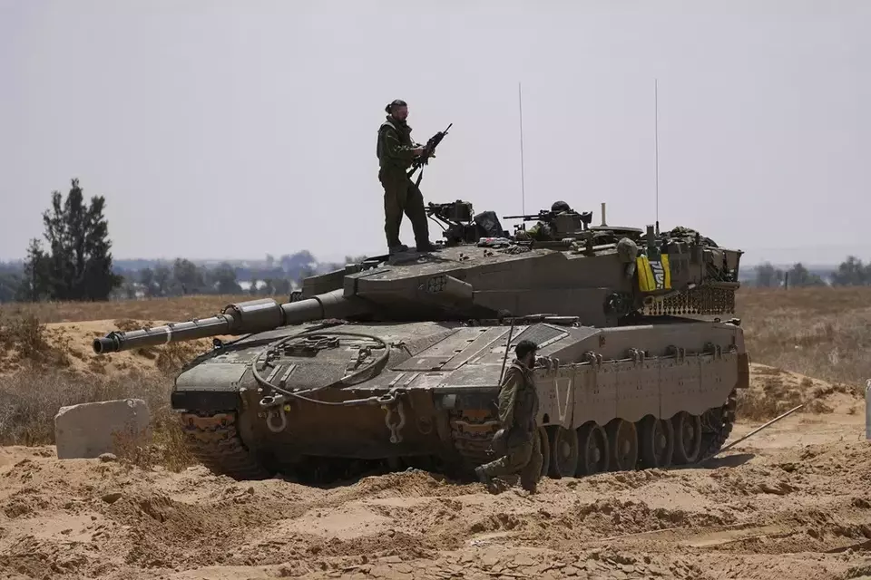 Israeli soldiers are seen near the border with the Gaza Strip, in southern Israel, Tuesday, May 7, 2024. (AP Photo/Tsafrir Abayov)