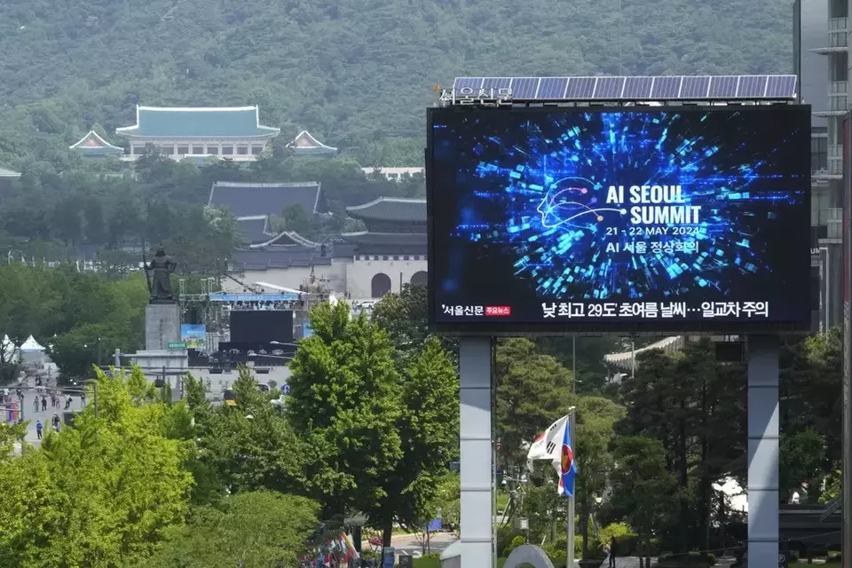 A screen shows an announcement of the AI Seoul Summit in Seoul, South Korea, Tuesday, May 21, 2024. (AP Photo/Ahn Young-joon)