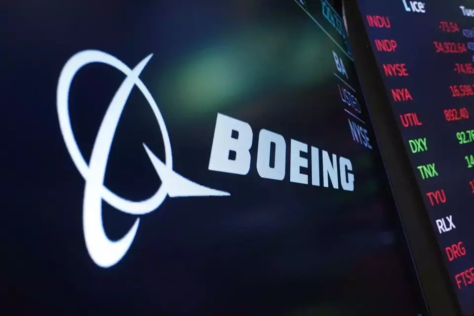 FILE - The logo for Boeing appears on a screen above a trading post on the floor of the New York Stock Exchange, July 13, 2021. (AP Photo/Richard Drew, File)