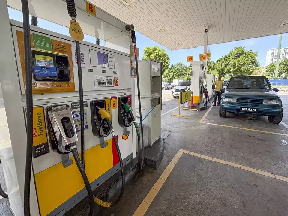 A car owner pumps at a petrol station in Kuala Lumpur, Malaysia, Monday, June 10, 2024. (AP Photo/Vincent Thian)