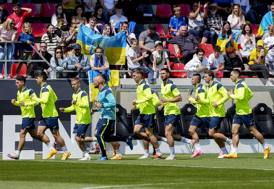 Players of the Ukrainian national soccer team warm up during a public training session in Wiesbaden, Germany, Thursday, June 13, 2024, ahead of their group E match against Romania at the Euro 2024 soccer tournament. (AP Photo/Michael Probst)