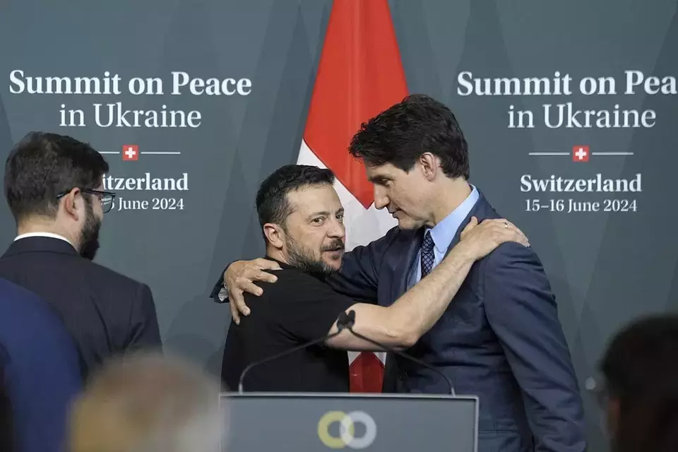 Ukrainian President Volodymyr Zelenskyy hugs Canada Prime Minister Justin Trudeau during the closing press conference of the Ukraine peace summit in Switzerland, Sunday, June 16, 2024. (AP Photo/Laurent Cipriani)