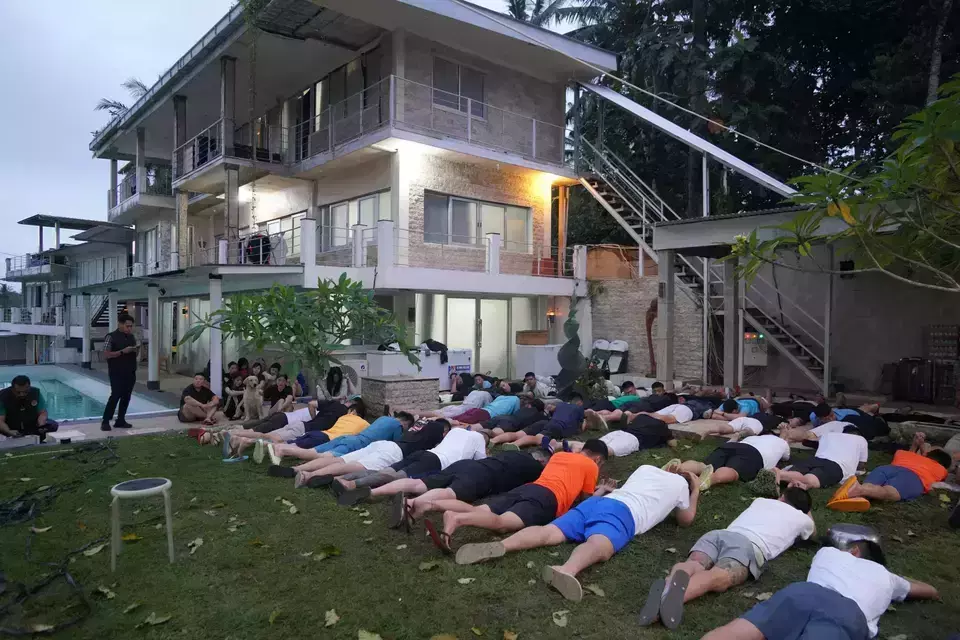 Immigration officials apprehend hundreds of foreign nationals at a villa in Marga District, Tabanan Regency, Bali, on suspicion of residence permit misuse and cybercrime, Wednesday, June 26, 2024. (Photo courtesy of Bali Immigration Office)