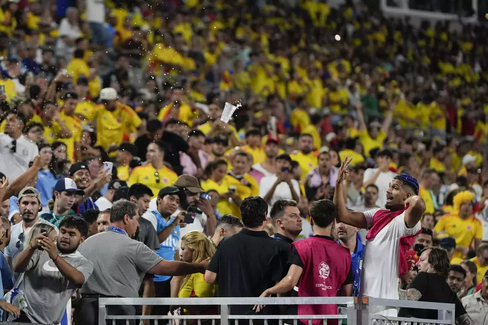 Uruguay's Ronald Araujo, right, argues with fans at the end of a Copa America semifinal soccer match against Colombia, Wednesday, July 10, 2024, in Charlotte, N.C. (AP Photo/Julia Nikhinson)