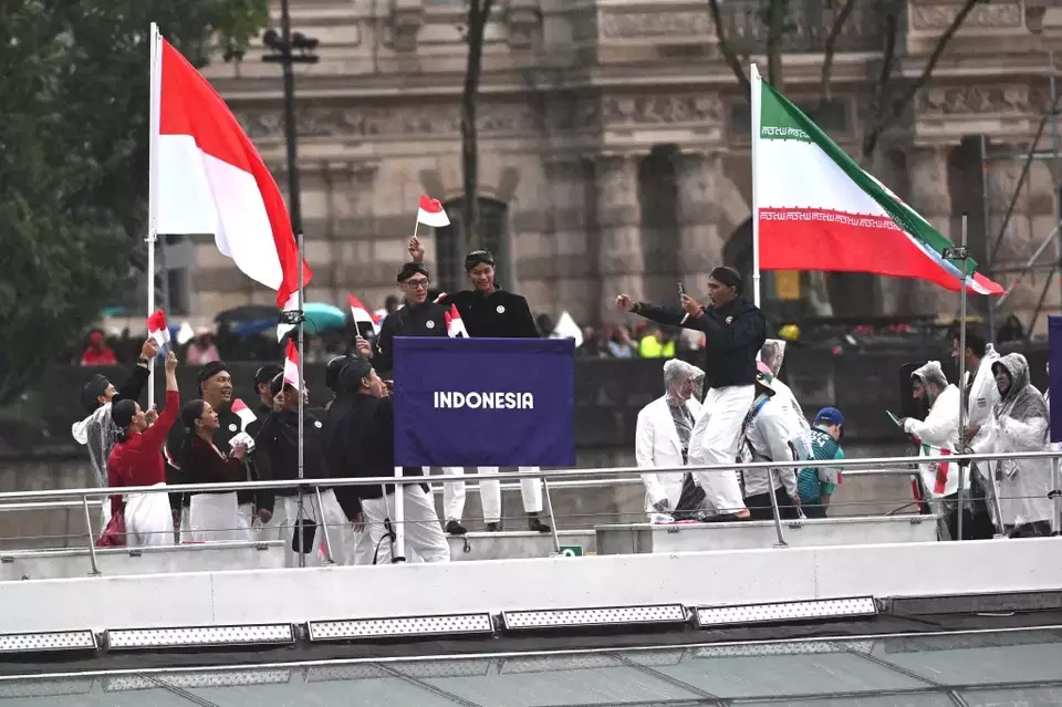 The Indonesian delegation parades aboard a boat along the Seine River during the opening ceremony of the Paris 2024 Olympics in Paris, France, on Friday, July 26, 2024. (NOC Indonesia)